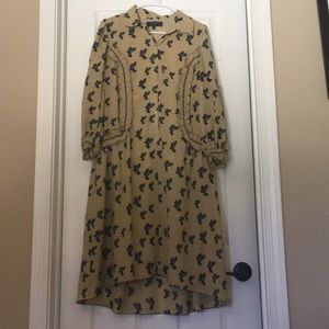 Tan long sleeve button up dress with bird print.